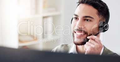 Im sure I can find a solution for you. a handsome young male call center agent working in his office.