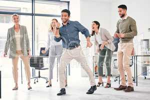 Dance the stress away. Full length shot of a diverse group of businesspeople standing together and dancing in the office.