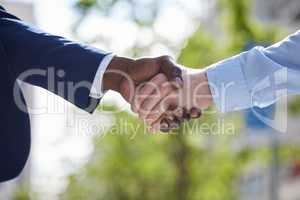 Opportunity is everywhere, if youre looking. two unrecognizable businesspeople sharing a handshake outside.