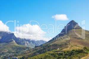 View of mountains with a path and cityscape against blue sky copyspace. A peaceful mountain with a scenic background in quiet Lions Head in Cape Town, South Africa. Nature backdrop with a hill top