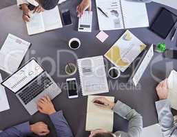 Weve got lots to do. Aerial shot of a group of businesspeople working together in an office.