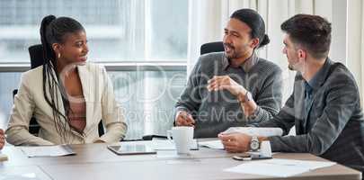 Their meetings are insightful. a group of businesspeople having a meeting in a boardroom at work.