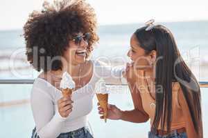 The sisterhood is strong with these two. two young friends enjoying ice cream cones while hanging out at the promenade.