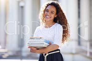 Happiness is a journey, not a destinatio. a young woman carrying her schoolbooks outside at college.