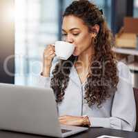 Time to fuel the fire. a young businesswoman enjoying a cup of coffee while working.