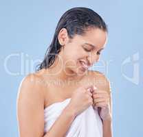 Feeling fresh and ready to get dressed. a woman holding a towel around her after washing.