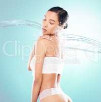 Personal hygiene is essential for maintaining good health. a beautiful young woman being splashed with water against a studio background.