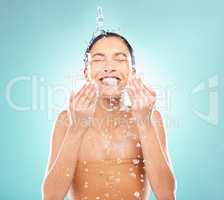 Personal hygiene is essential. a young woman doing her daily skincare routine against a blue background.