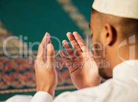 We are to pray in times of adversity. a unrecognizable muslim male praying in a mosque.