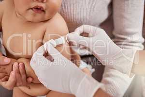 A few days and youll feel better. a doctor applying a plaster on a babys arm.