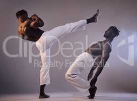 Strength does not come from the physical capacity. two men fighting against a grey background.
