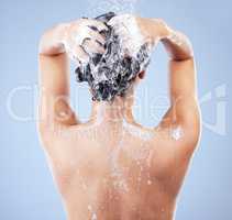 Hair care is important. an unrecognizable woman washing her hair in the shower against a blue background.