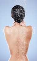 Time for some cleansing. an unrecognizable woman washing her hair in the shower against a blue background.