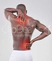 Suffer the pain of self-discipline. a man experiencing back pain against a studio background.