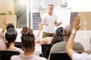 In charge for a reason. a handsome mature businessman giving a presentation in the conference room.