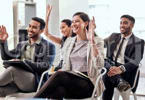 Curiosity help you learn. a group of businesspeople raising their hands in a meeting at work.