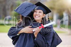 Congratulations are in order. an attractive young female student hugging her friend while celebrating on graduation day.