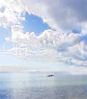 Kayak, canoe or rowboat on a beautiful ocean, beach or sea with clouds in sky background outdoors. Scenic view of calm waves of water at a coast with relaxing, peaceful and bright landscape in nature