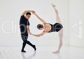 Steady hand to hold a perfect pose. Studio shot of a young couple rehearsing their routine.