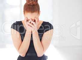 The life of a professional ballerina is full of unknowns. Closeup shot of a young ballerina looking sad.