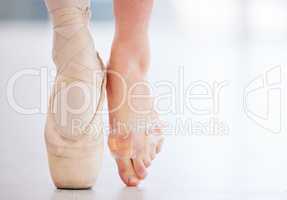 The plus side is that I finally perfected my pointe technique. a young ballerina wearing a pointe shoe on one foot and band aids on her barefoot.