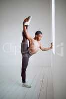 Ballet training requires resilience and hard work. a young boy practicing his routine in a dance studio.