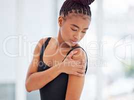 Give your body time to recover. a young ballerina suffering from shoulder pain.