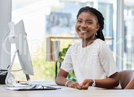 Find a job that brings you joy. a young businesswoman sitting at a desk in an office at work.