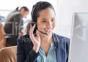 Lets find you a solution. an attractive young female call center agent working at her desk in the office.