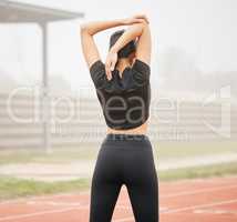 The only limitations that exist are the ones that you allow to exist. an athletic young woman stretching while out on the track.