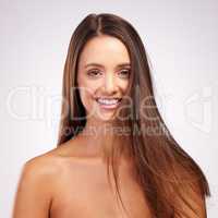Haircare is a priority of mine. Studio portrait of an attractive young woman posing against a grey background.