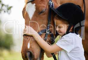 You have won a friend for life. a little girl hugging a horse outside.