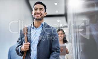 Change your thoughts and it will change your life. a business smiling while walking through the office.