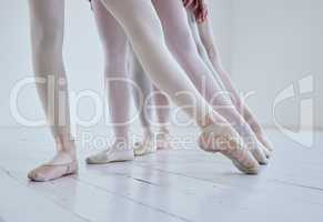 Points of purpose. a group of ballerinas with toes pointed.