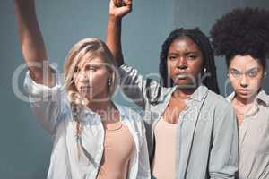 Diverse female activists or protesters fists up fighting for freedom and human rights. A group of black lives matter supporters raising awareness for the political liberal movement and social justice