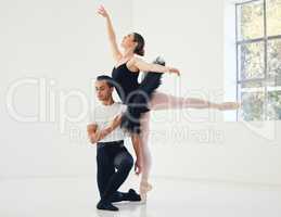 Elegantly refined. Studio shot of a young couple rehearsing their routine.