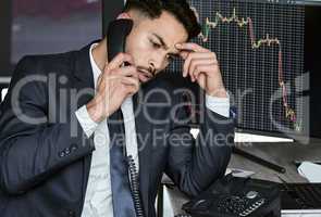 Stressed businessman on the phone, trading on the stock market during a financial crisis. Trader in a bear market with stocks crashing. Market crash and economy depression or failure