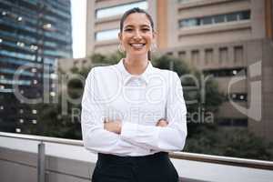 Confidence is so empowering. Portrait of a confident young businesswoman standing with her arms crossed on a balcony outside an office.