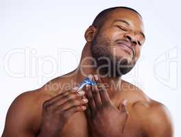 Ow. Studio shot of a handsome young man wincing in pain after cutting himself while shaving against a white background.