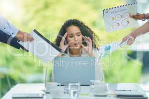 I need an escape. a young businesswoman experiencing a headache while being overwhelmed with work.
