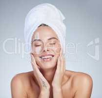 I CAN keep my hands to myself. Studio portrait of an attractive young woman moisturizing her face against a grey background.