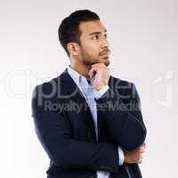 Putting things into perspective. Studio shot of a young businessman looking thoughtful against a white background.