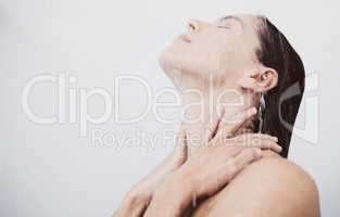 Let the steam soothe you. a young woman rinsing her hair during a shower.