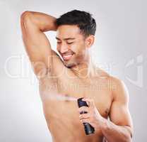 Preparation is confidence. Studio shot of a handsome young man applying deodorant.