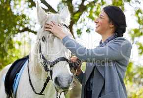 Horses lend us the wings we lack. an attractive young woman standing with her horse in a forest.