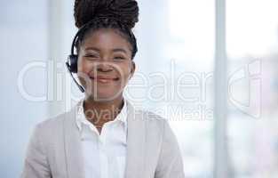 Shes proven her worth as the top saleswoman. Portrait of a young businesswoman wearing a headset while working in an office.