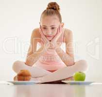 Whats good is a healthy appreciation for food. a young ballerina deciding what to eat in a studio.