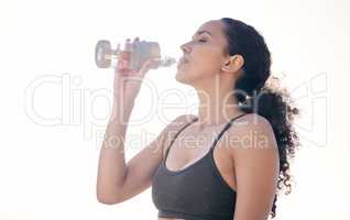 Water tastes even better after a workout. a fit young woman drinking water while out for a workout.