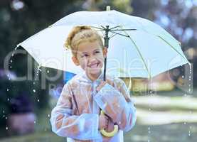 Rainy days are the best. a little girl playfully standing in the rain holding her umbrella.