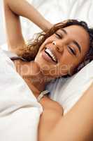 Talk about a good nights sleep. an attractive young woman lying in her bed in the morning at home.